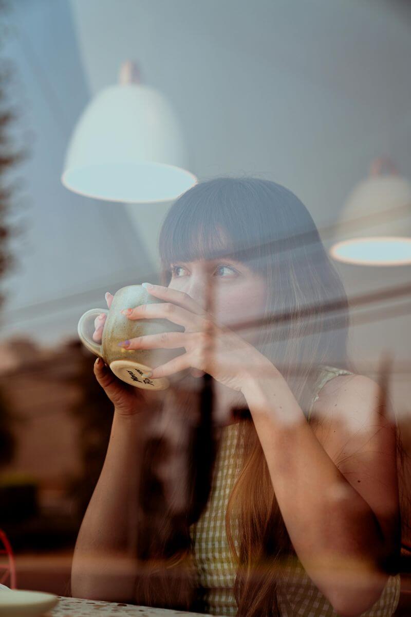 Image: Someone integrating contemplation into daily life — perhaps during morning coffee, a commute, or a brief pause at work.
